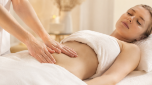 Gentle self lymphatic drainage massage on abdomen for detox and lymph circulation