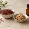 Red yeast rice and natto arranged with a closed amber glass vial in an editorial still life